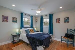 a bedroom with a bed with blue drapes at JB`s Place · JB`s Place in Brevard