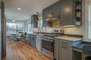 a large kitchen with stainless steel appliances and wood floors at JB`s Place · JB`s Place in Brevard