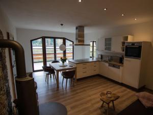 a kitchen with a table and a dining room at Ferienwohnung Maulbetsch in Alpirsbach