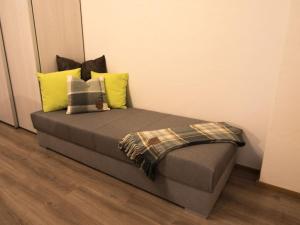 a bed in a room with yellow pillows at Ferienwohnung Maulbetsch in Alpirsbach
