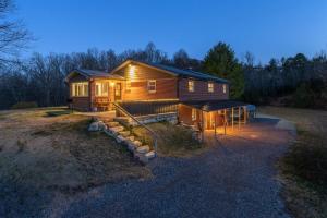 a small house with lights on in a yard at JB`s Place · JB`s Place in Brevard