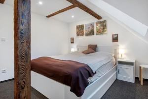a bedroom with a bed in a white room at gemütliche Ferienwohnung in Seenähe in Neustrelitz