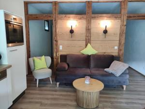 a living room with a couch and a table at Ferienwohnung Maulbetsch in Alpirsbach