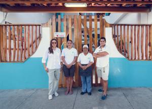 a group of people standing in front of a door at Galapagos Native in Puerto Ayora +96 photos
