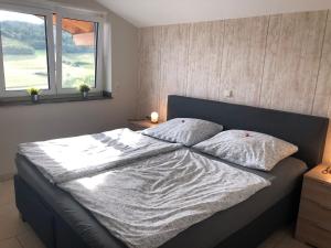 a bed with two pillows on it in a bedroom at Fewo Stremme in Altenlotheim