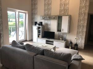 a living room with a couch and a television at Fewo Stremme in Altenlotheim