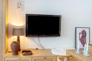 a flat screen tv hanging on a wall above a desk at Ferienwohnung Schluchsee Idylle in Schluchsee