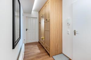a hallway with a wooden cabinet and a mirror at Ferienwohnung Schluchsee Idylle in Schluchsee