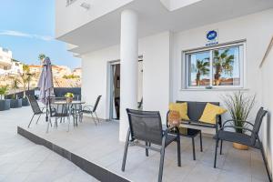 a patio with chairs and a table on a patio at Sungolfbeach El Girasol in Orihuela