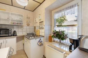 a kitchen with a sink and a window at Ferienwohnung am Bloschk in Schwielochsee