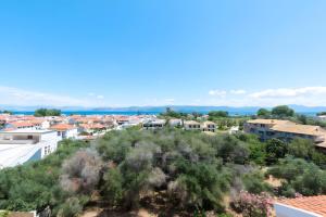 a view of a city with houses and trees at Roys Blu in Kavos