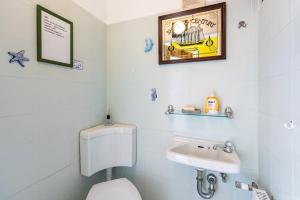 a bathroom with a toilet and a sink at Ferienwohnung Devich in Oersberg +17 photos