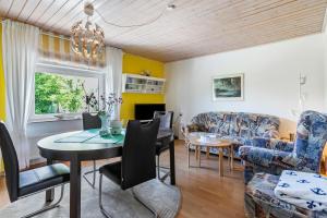 a living room with a table and chairs at Ferienwohnung Devich in Oersberg