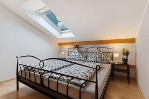 a bedroom with a bed and a skylight at Weingut Ringwald in Herbolzheim +41 photos