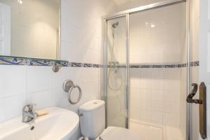 a bathroom with a toilet and a shower and a sink at Plaza Cadiz 4 overlooking Playazo in Nerja +23 photos