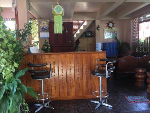 a barber shop with two bar stools in a room at Chok-wasana Guest House in Mae Sariang