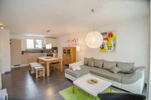 a living room with a couch and a table at Bianca's Kaiserstuhl in Ihringen