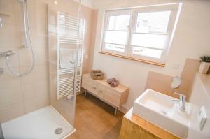 a bathroom with a shower and a sink at Bianca's Kaiserstuhl in Ihringen +13 photos