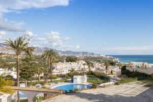 a view of a city with a swimming pool and the ocean at Plaza Cadiz 4 overlooking Playazo in Nerja