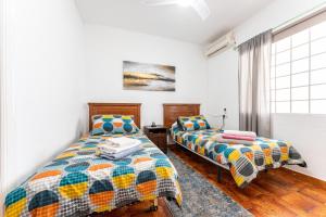 two beds sitting next to each other in a room at Superbly situated villa 67 in Mijas Costa +17 photos