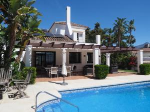 a villa with a swimming pool and a house at El Cafetal de Veronica in Marbella