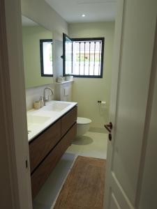 a bathroom with a sink and a toilet and a window at El Cafetal de Veronica in Marbella +29 photos