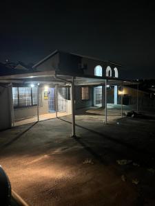 an empty parking lot in front of a building at night at 85 Hidden Gem in Newlands