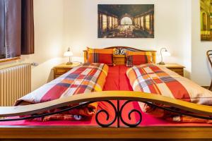 a bedroom with two beds and two night stands at Altes Pfarrhaus in Vöhrenbach