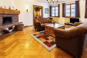 a living room with two couches and a fireplace at Altes Pfarrhaus in Vöhrenbach