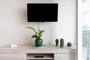 a living room with a tv on a white wall at Casa di Titina a Otranto in Otranto
