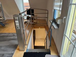 a spiral staircase in a building with a person at Galeriewohnung mit Seeblick in Absberg