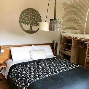 a bedroom with a bed with a black and white blanket at La Baïta De La Foux in La Foux d'Allos