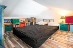 a bedroom with a large bed in a room with bookshelves at Appartement de charme - spa privé in Biarritz