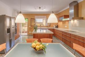 a kitchen with a table with a bowl of fruit on it at Casa Caterina in Port de Soller
