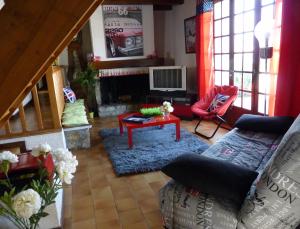 a living room with a couch and a fireplace at Maison Am Stram Gram in La Tranche-sur-Mer