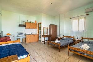 a room with two beds and a kitchen at Vangelis studio 1 in Kefalonia
