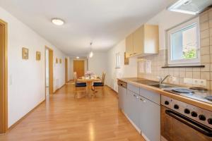 a kitchen with a table and a dining room at Ferienwohnungen große Albferien in Heroldstatt