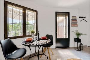 a dining room with a table and chairs and windows at Appartment Patricia in Orba