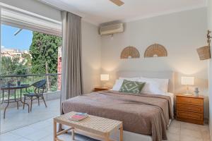 a bedroom with a bed and a balcony at Panorama Apartments in Skoutari