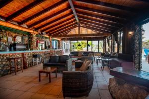 a restaurant with couches and tables and a bar at Mirage Arillas Studio Type B15 in Arillas