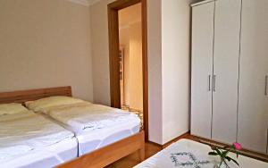 a bedroom with a bed and a cabinet and a table at Villa Karlsbach in Teisendorf