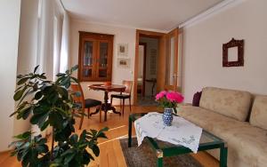 a living room with a couch and a table at Villa Karlsbach in Teisendorf