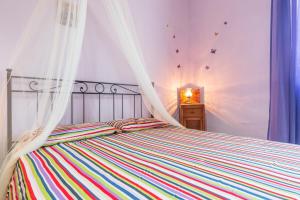 a bedroom with a bed with a mosquito net at Casale siculo in Avola