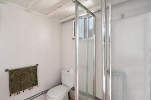 a bathroom with a toilet and a glass shower at Casa Cueva Tejeda 2 dorm in Tejeda +22 photos