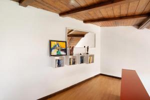 a room with a white wall with paintings on it at Casa Cueva Tejeda 2 dorm in Tejeda