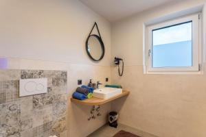 a bathroom with a sink and a mirror at Luisalle Top 6 in Auffach +17 photos