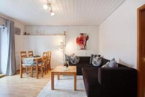 a living room with a couch and a table at Ferienhaus am Blumengässle in Feldberg