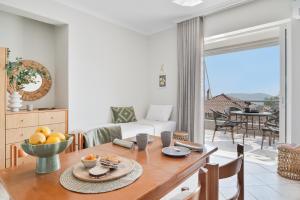 a living room with a table with a bowl of fruit at Panorama Apartments in Skoutari +42 photos