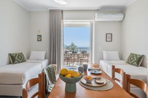 a living room with a table with fruit on it at Panorama Apartments in Skoutari