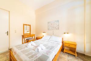 a bedroom with a bed and a mirror at Arianna apartment 14 in Paleokastritsa